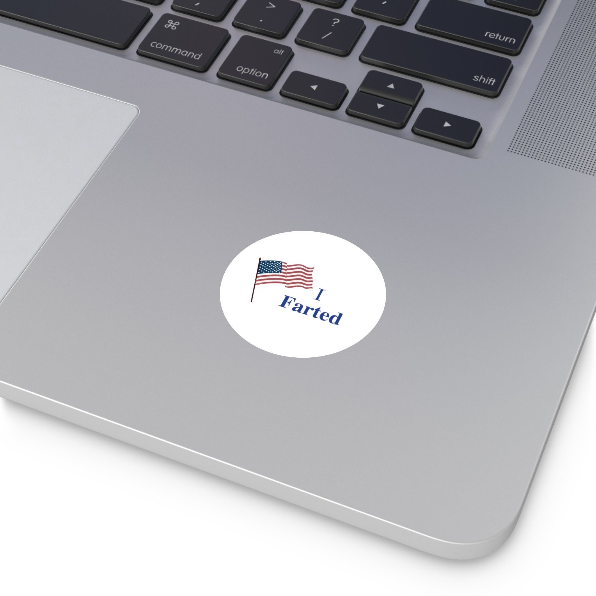 Sticker with 'I Farted' text and American flag on a laptop