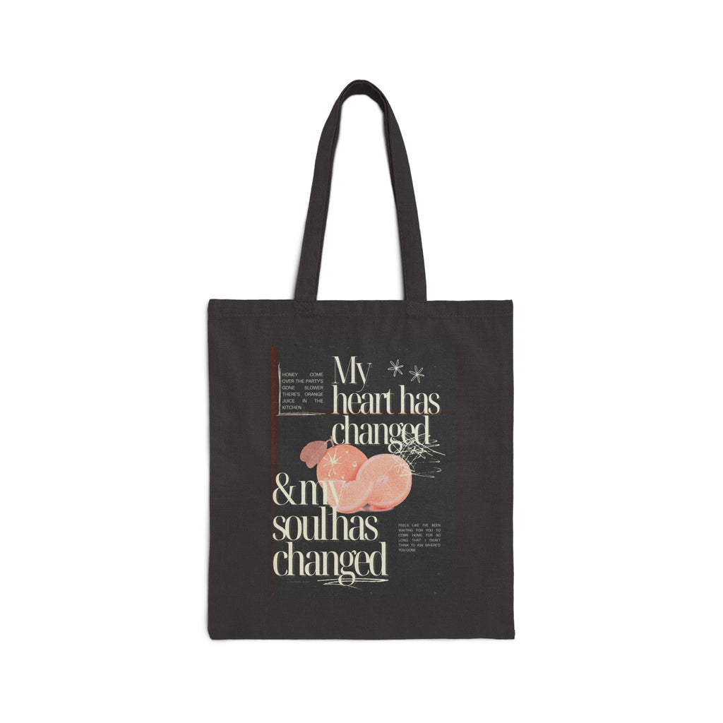 Black tote bag with text and fruit design on a white background
