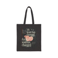 Black tote bag with text and fruit design on a white background