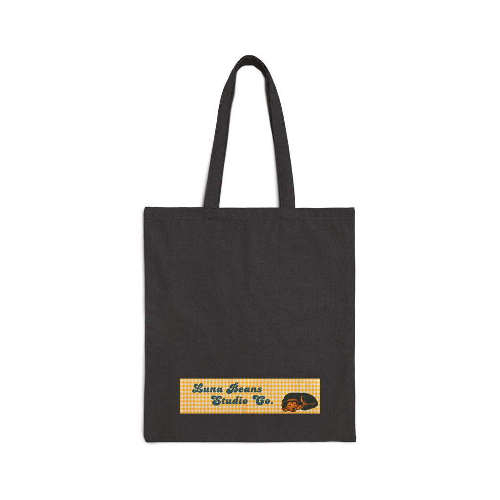 Black tote bag with a small logo on a white background
