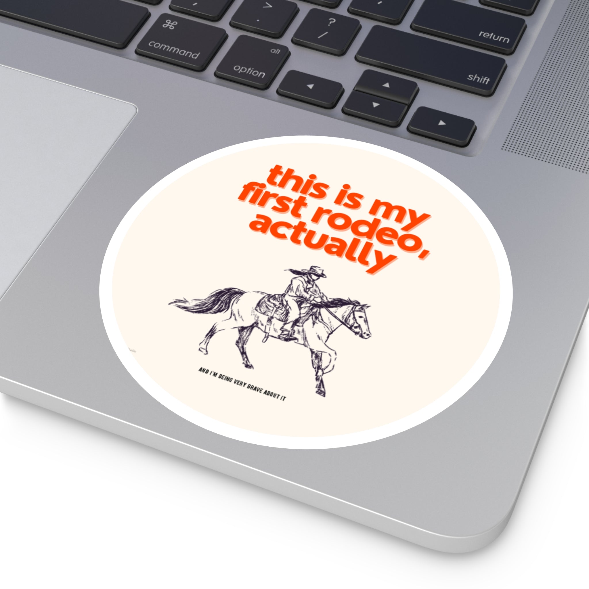 Sticker with a cowboy graphic and text on a laptop